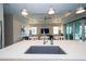 Open kitchen with an island featuring a sink and stainless-steel appliances, overlooking the living room and outdoor patio at 19877 Sea Glass Cir, Land O Lakes, FL 34638