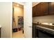 Convenient laundry room with front-load washer and dryer, cabinetry, and additional shelving at 19877 Sea Glass Cir, Land O Lakes, FL 34638