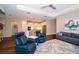Open concept living space with recessed lighting, wood floors, and seamlessly flows into a stylish white kitchen at 19877 Sea Glass Cir, Land O Lakes, FL 34638