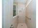 Walk-in shower with tile surround, a built-in niche, and grab bar at 19877 Sea Glass Cir, Land O Lakes, FL 34638