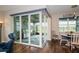 Enclosed sunroom features sliding glass doors, beautiful flooring, and views of the outdoors at 19877 Sea Glass Cir, Land O Lakes, FL 34638