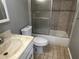Cozy bathroom featuring a shower-tub combination and neutral-toned tiling at 2068 San Marino N Way, Clearwater, FL 33763
