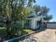Exterior view of a charming home showcasing its unique facade and mature landscaping at 2068 San Marino N Way, Clearwater, FL 33763