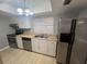 A functional kitchen featuring stainless steel appliances, ample cabinet space, and tile flooring at 2068 San Marino N Way, Clearwater, FL 33763