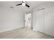 Spacious bedroom with ceiling fan, wood-look floors, closet and bright white walls at 2157 20Th Sw Ave, Largo, FL 33774