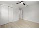 Bedroom featuring ceiling fan, light walls, light wood-look floors and closet at 2157 20Th Sw Ave, Largo, FL 33774