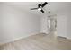 Spacious bedroom featuring a ceiling fan, bright white walls, and sliding closet doors at 2157 20Th Sw Ave, Largo, FL 33774