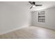 Bright bedroom featuring light walls, light wood-look flooring, and a modern ceiling fan at 2157 20Th Sw Ave, Largo, FL 33774