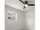 Neutral bedroom features a modern ceiling fan, window and light-colored wood-look floors at 2157 20Th Sw Ave, Largo, FL 33774