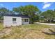 Charming single-story home featuring a textured exterior, a dark roof, and a well-maintained front lawn at 2157 20Th Sw Ave, Largo, FL 33774