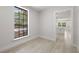Bright hallway with wood look flooring and large window overlooking backyard at 2157 20Th Sw Ave, Largo, FL 33774