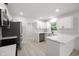 Stylish kitchen featuring white cabinets, stainless steel appliances, and a bright atmosphere, designed for modern living at 2157 20Th Sw Ave, Largo, FL 33774