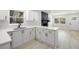 Bright kitchen featuring white cabinets, quartz countertops, stainless steel faucet and black fireplace at 2157 20Th Sw Ave, Largo, FL 33774