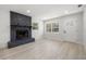 Bright living room showcasing a striking stone fireplace, natural light, and wood-look floors, perfect for relaxing at 2157 20Th Sw Ave, Largo, FL 33774