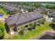 Aerial view showcases the back of this townhome, spacious yard, and pond at 2234 Lennox Dale Ln, Brandon, FL 33510