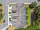 Overhead view of townhomes with gray roofs, individual driveways, and a small pond at 2234 Lennox Dale Ln, Brandon, FL 33510