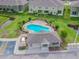 An aerial view of the community pool and pool house, surrounded by lush landscaping and community buildings at 2234 Lennox Dale Ln, Brandon, FL 33510