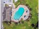Aerial view of a kidney-shaped pool with surrounding lounge chairs and landscaped area at 2234 Lennox Dale Ln, Brandon, FL 33510