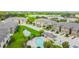 Aerial view showcasing a community pool, townhomes, and a scenic pond at 2234 Lennox Dale Ln, Brandon, FL 33510