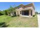 Spacious backyard with lush green grass and a screened in patio at 2234 Lennox Dale Ln, Brandon, FL 33510