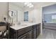 Modern bathroom features double vanity with sleek countertops and updated fixtures at 2234 Lennox Dale Ln, Brandon, FL 33510