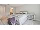 Cozy bedroom with white walls, a comfortable bed, stylish side tables, and light-colored flooring at 2234 Lennox Dale Ln, Brandon, FL 33510