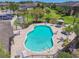 Kidney-shaped community pool with a sundeck, lounge chairs, and nearby seating areas at 2234 Lennox Dale Ln, Brandon, FL 33510