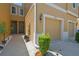 Close-up of two-story townhome exterior, attached garage and inviting front entrance with landscaping at 2234 Lennox Dale Ln, Brandon, FL 33510