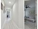 Bright hallway leads to bedroom with neutral paint and wood floors at 2234 Lennox Dale Ln, Brandon, FL 33510