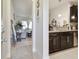 View of hallway with access to the living room and kitchen featuring dark cabinets at 2234 Lennox Dale Ln, Brandon, FL 33510