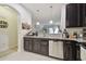 Modern kitchen featuring stainless steel appliances, granite countertops, and dark cabinetry at 2234 Lennox Dale Ln, Brandon, FL 33510