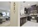 Open-concept kitchen with stainless appliances, granite countertops, and views into the living room at 2234 Lennox Dale Ln, Brandon, FL 33510
