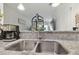 Close-up of a stainless steel double sink with granite countertops and modern faucet at 2234 Lennox Dale Ln, Brandon, FL 33510