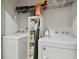Efficient laundry room with full size washer and dryer and built in shelving at 2234 Lennox Dale Ln, Brandon, FL 33510