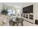 Bright living room featuring tile floors, tv console, neutral decor and access to the outdoor patio at 2234 Lennox Dale Ln, Brandon, FL 33510