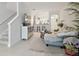 Open concept living room with staircase, neutral decor, tile floors and opening to the eat-in kitchen at 2234 Lennox Dale Ln, Brandon, FL 33510