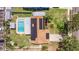 An aerial view showcasing a backyard pool, patio, and solar panels, all within a fenced yard at 2401 66Th S Ave, St Petersburg, FL 33712