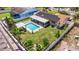 Aerial view showcasing the backyard pool, patio, fenced yard and solar panels of the home at 2401 66Th S Ave, St Petersburg, FL 33712