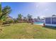 Spacious backyard with well-maintained lawn, pool, pergola, and tropical landscaping, perfect for outdoor enjoyment at 2401 66Th S Ave, St Petersburg, FL 33712