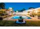 A serene backyard with a swimming pool, pergola, string lights, landscaping and ample green space for Gathering enjoyment at 2401 66Th S Ave, St Petersburg, FL 33712