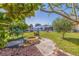 Large backyard with a fire pit, pergola covered chairs, and tropical greenery creating a relaxing outdoor space at 2401 66Th S Ave, St Petersburg, FL 33712