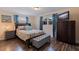 Cozy bedroom features wood floors, dresser with TV, and ottoman bench at 2401 66Th S Ave, St Petersburg, FL 33712