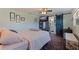 Comfortable bedroom features a ceiling fan, mounted TV, and sliding barn door to the bathroom at 2401 66Th S Ave, St Petersburg, FL 33712