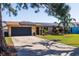 Lovely single Gathering home featuring a well-manicured lawn, solar panels, and attached garage at 2401 66Th S Ave, St Petersburg, FL 33712