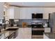 Charming kitchen features granite counters, stainless appliances and white cabinets at 2401 66Th S Ave, St Petersburg, FL 33712