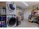 Organized laundry room features stacked washer and dryer and plenty of storage space with a neutral color palette at 2401 66Th S Ave, St Petersburg, FL 33712