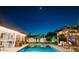 Outdoor pool at night with outdoor kitchen and pergola at 2401 66Th S Ave, St Petersburg, FL 33712
