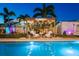A cozy backyard pool area featuring a pergola with string lights and comfortable seating, creating an inviting outdoor oasis at 2401 66Th S Ave, St Petersburg, FL 33712