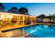 Backyard pool at dusk with outdoor kitchen and pergola at 2401 66Th S Ave, St Petersburg, FL 33712