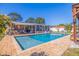 Backyard pool view features lush landscaping and outdoor entertaining area at 2401 66Th S Ave, St Petersburg, FL 33712